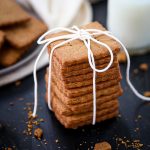 A stack of Homemade Graham Crackers tied up with a white string.