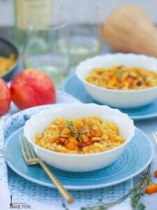 Butternut Squash and Apple Risotto served in a white bowl on a blue plate.