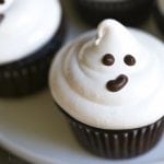 Close up of an easy ghost cupcake with marshmallow frosting and a cute chocolate face!