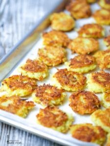 Mini Potato Latkes fresh out of the oven on a baking sheet.