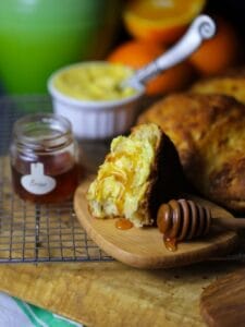 A wedge of Traditional Irish Soda Bread with Orange Butter drizzled with honey.