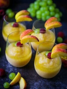Four Peach Sangria Slushies all poured and garnished.