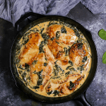 Cozy creamed spinach meets chicken in this new classic comfort dish. Make these chicken breasts with creamy spinach sauce in your cast iron skillet and serve it for a weeknight family dinner.