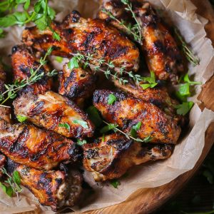 Garlic and Herb Grilled Chicken Wings garnished with fresh herbs