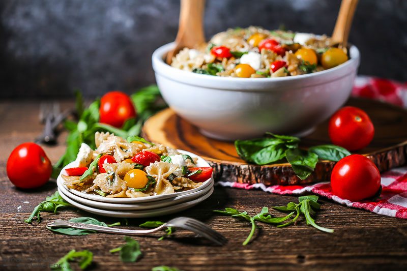 Italian Pasta Salad in a large bowl, with a serving alongside.