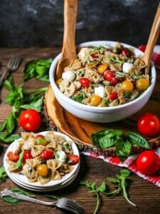 Italian Pasta Salad in a large bowl, with a serving alongside.