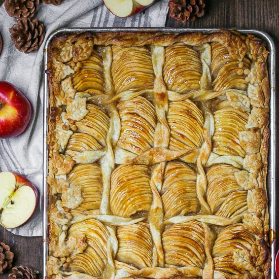 Overhead shot of Caramel Apple Slab Pie baked on a half sheet tray decorated with pastry leaves and twists.