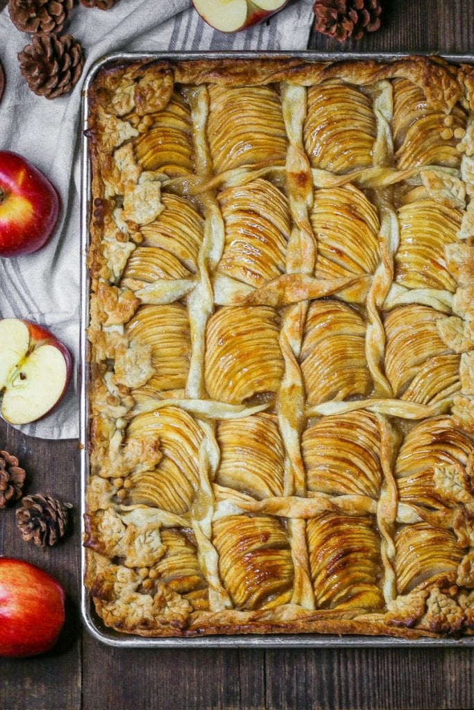 Overhead shot of Caramel Apple Slab Pie baked on a half sheet tray decorated with pastry leaves and twists.