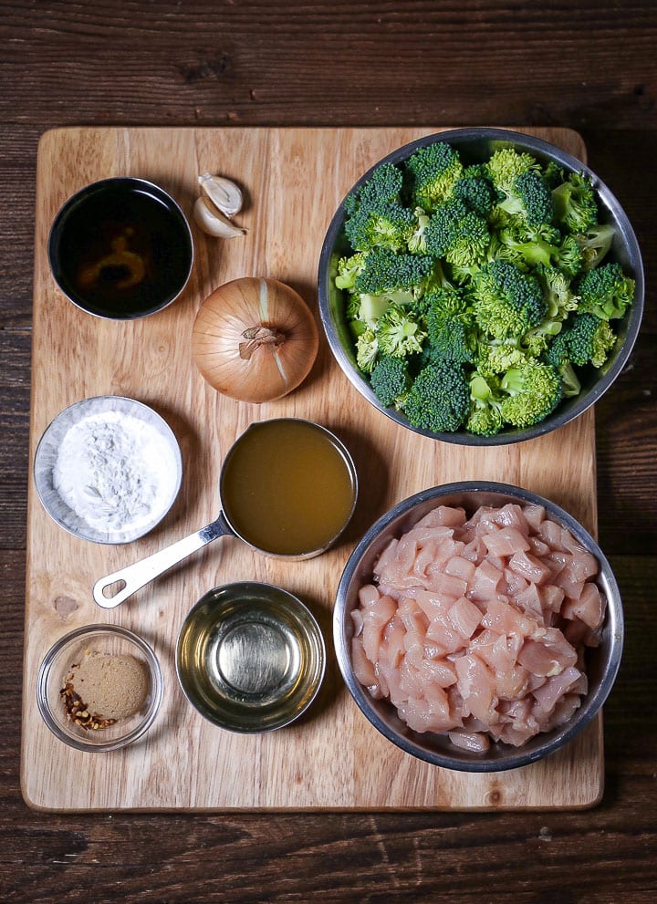 All the ingredients for Chicken and Broccoli Stir-Fry arranged on a cutting board.