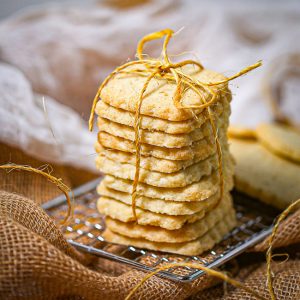A stack of classic shortbread cookies on a wire rack tied with twine.