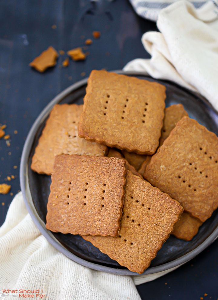 A plate of Homemade Graham Crackers on a round black plate.