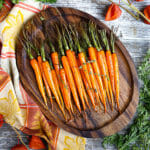Honey Glazed Carrots on a wooden serving tray.