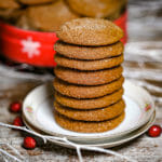 A stack of Soft Molasses Cookies on a small flowered plate.