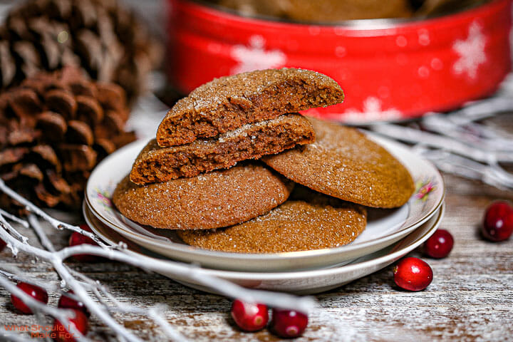 Soft Molasses Cookies on a plate with one cookie broken in half.