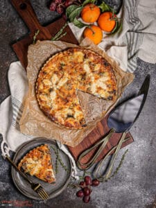 Overhead shot of a mushroom tart with a sliced removed and plated.