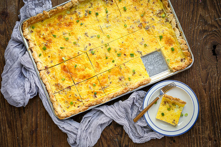 Sheet Pan Quiche Lorraine cut into squares with one square on a small round plate.