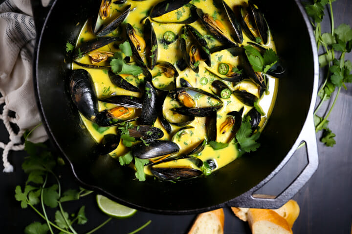 Close up of Curry Coconut Mussels sprinkled with cilantro.