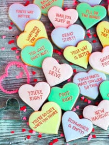 Vanilla and chocolate Conversation Heart Cookies inscribed with funny messages.