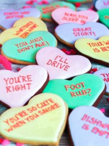 A close up of Conversation Heart Cookies inscribed with funny messages.