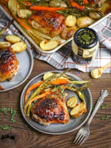 A serving of mustard glazed sheet pan chicken with veggies.