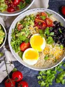 A close up of a Mexican Breakfast Bowl with Oatmeal topped with a runny egg.
