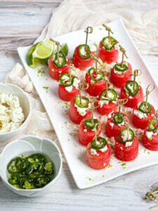 Margarita Watermelon Bites with cojita cheese and candied jalapeños on the side.
