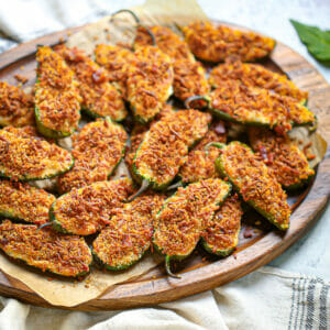 Crispy jalapeno poppers on a wood tray ready for serving.