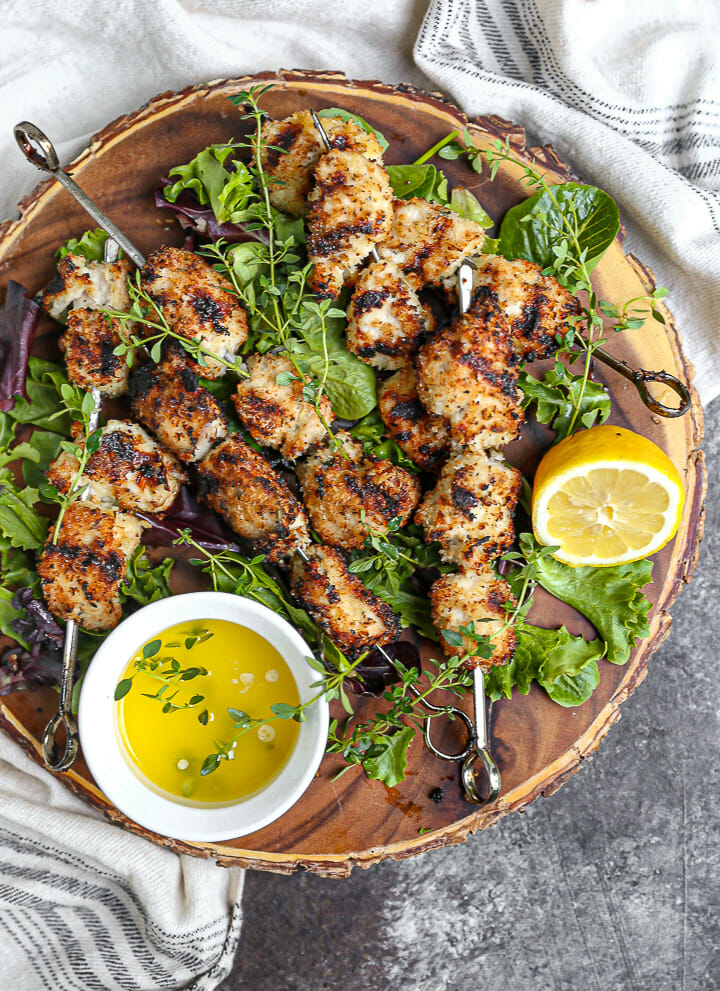 Breaded Chicken Skewers fresh off the grill served with lemon butter sauce.