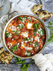 Shakshuka with Lamb Meatballs served in silver saute pan.