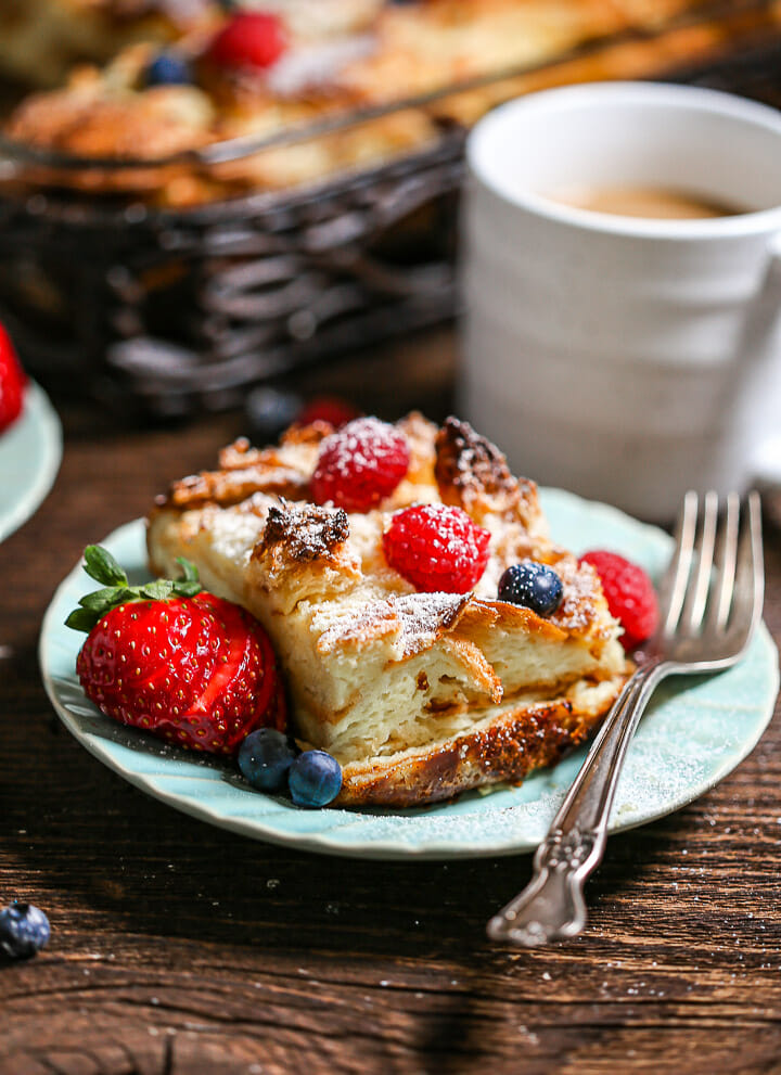 A serving of bake french toast casserole on a small blue plate.