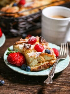 A serving of bake french toast casserole on a small blue plate.
