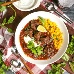Dig into this dish of mexican stew served with a beer, lime crema, and lots of fresh cilantro.