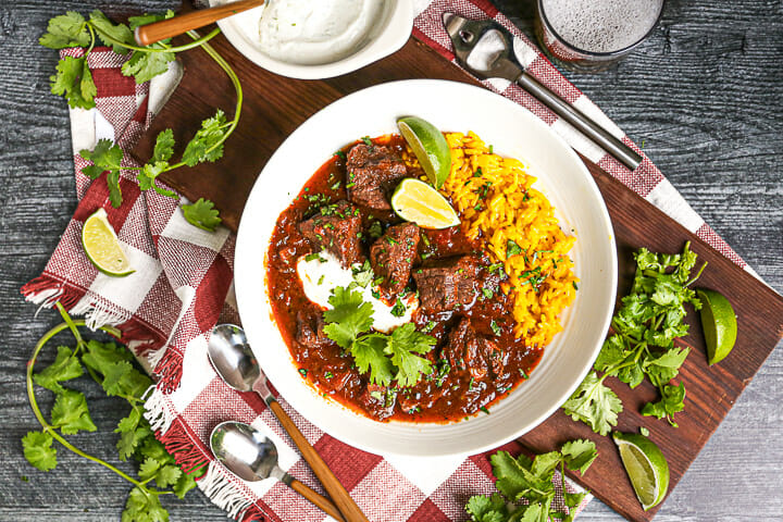 Dig into this dish of mexican stew served with a beer, lime crema, and lots of fresh cilantro.