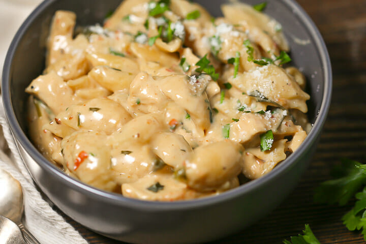 A serving of creamy chicken pasta in a gray bowl