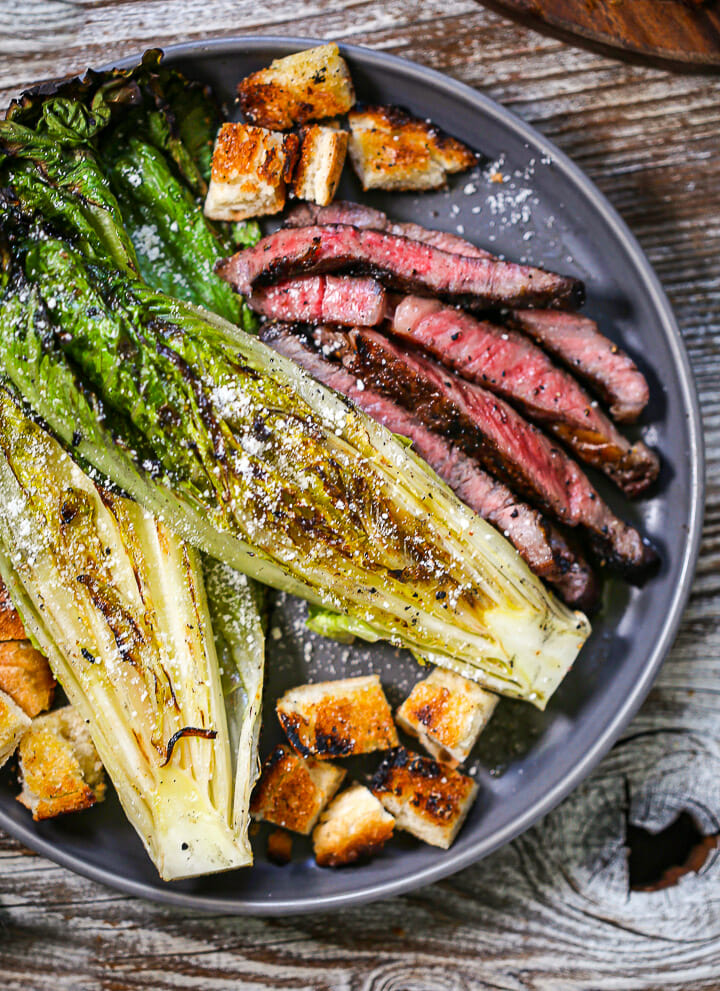 Close up of grilled romaine, steak and croutons.