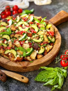 Dig into this garden fresh panzanella topped with fresh basil.