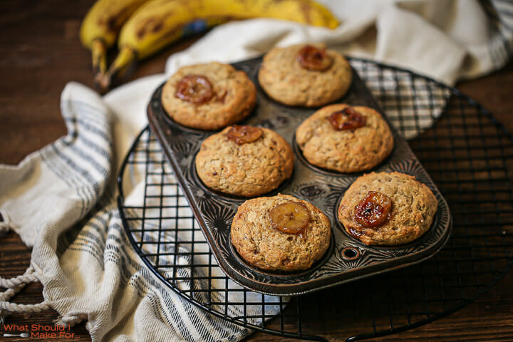 Caramelized banana muffins on a cooling rack fresh out of the oven.