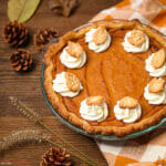 A sweet potato pie with marshmallow whipped cream ready for serving.