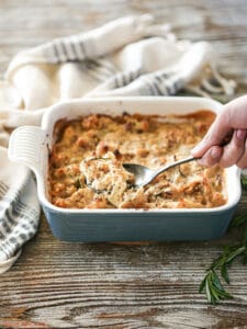 Scooping out a serving of a Roasted Cauliflower Gratin.