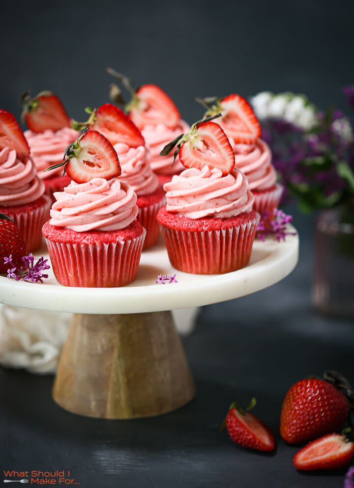 Strawberry cupcakes arranged on a cake plate.