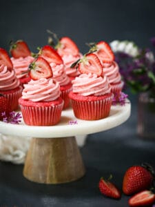 Strawberry cupcakes arranged on a cake plate.